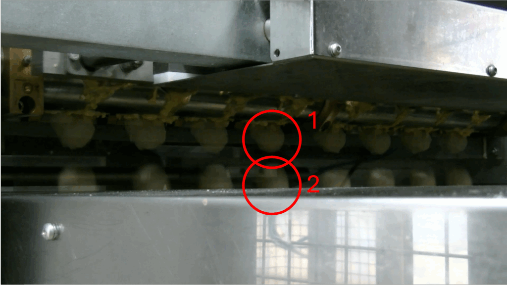 Overlaid video frames showing dough balls dropping at different times from identical nozzles